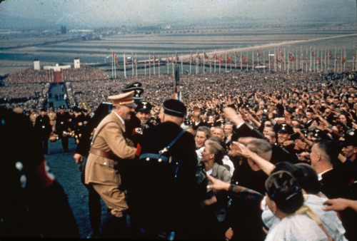 disclosur: Adolf Hitler greets the cheering throng at a rally in 1937 Photo by: Hugo Jaeger