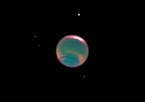 View of Neptune in the infrared, showing bands of methane in its atmosphere captured by the Hubble S