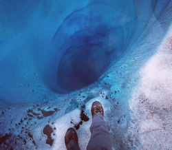 blackphoenixalchemylab:  A 1000 ft hole found at Lower Ruth Glacier in Alaska covered only by a sheet of clear ice. Photographed by National Geographic photographer Aaron Huey.(via Imgur) 