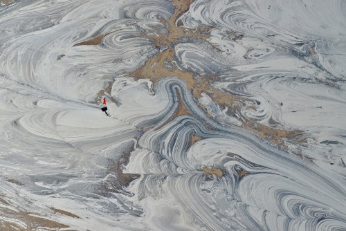 Tarry iceWhile this photo (with person for scale) might remind us of swirling bits of moraine in flo