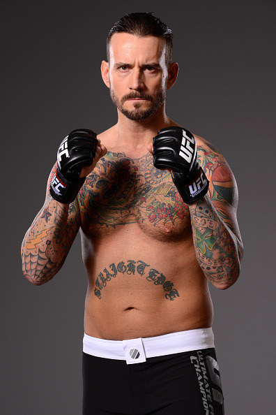 thepunknation:UFC Photoshoot Part Two‘DALLAS, TX - MARCH 13:  Phil ‘CM Punk’ Brooks poses for a photo during a UFC photo session at the Hilton Anatole Hotel on March 13, 2015 in Dallas, Texas. (Photo by Mike Roach/Zuffa LLC/Zuffa LLC via Getty