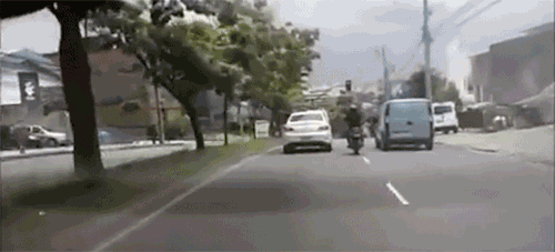 Motorcycle idiot fighting a car.