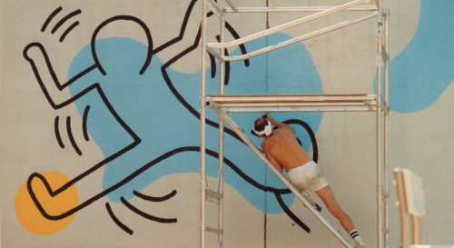 Keith Haring paints a mural at Clarkson St. and Seventh Ave. in Manhattan, August 20, 1987. Photogra