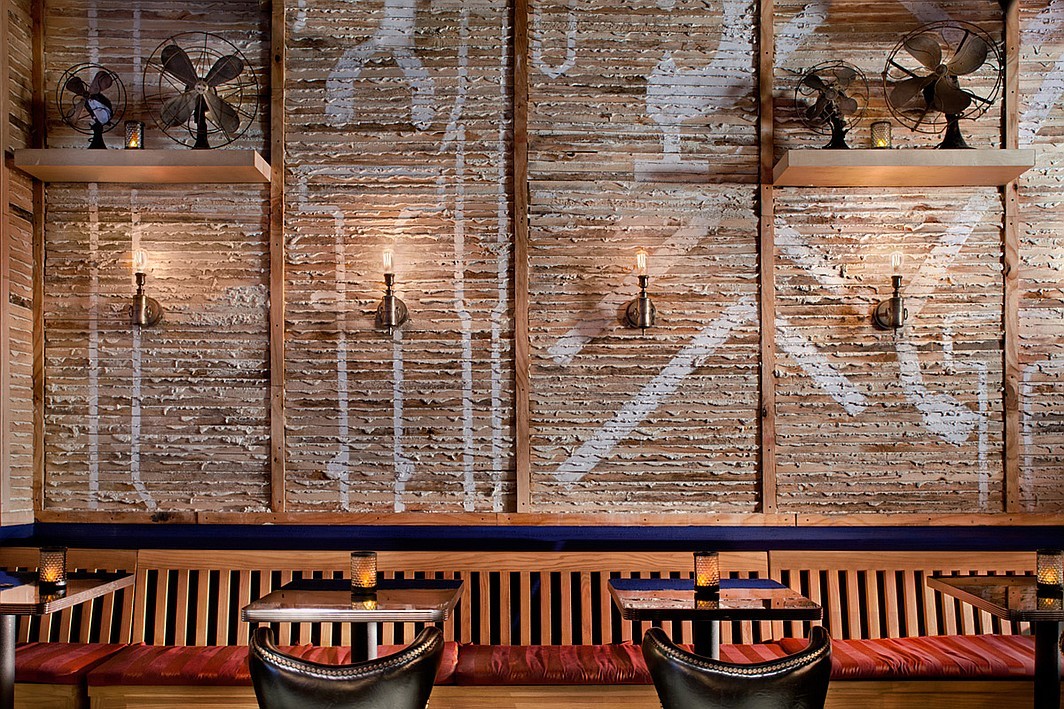 Meet the design firm, ICRAVE, behind this peeled back bar area at NYC’s The General, featuring exposed plaster, wood, and bare bulb sconces. Photography by John Bartelstone.