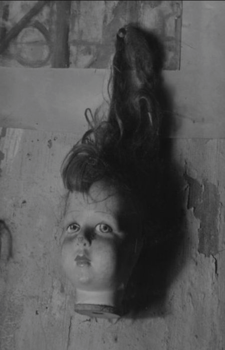 kvetchlandia:Pierre Jahan     Doll’s Head Hanging from a Wall, Paris     1945