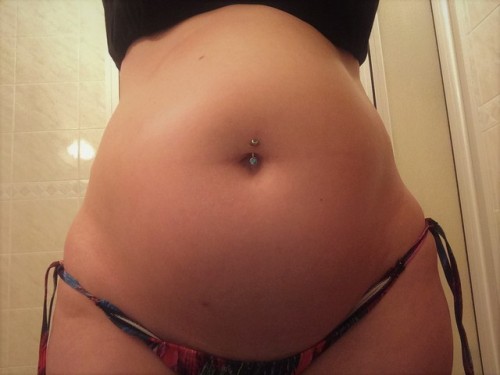 swollenbellygirl: Swollen belly oiled up and in a bikini