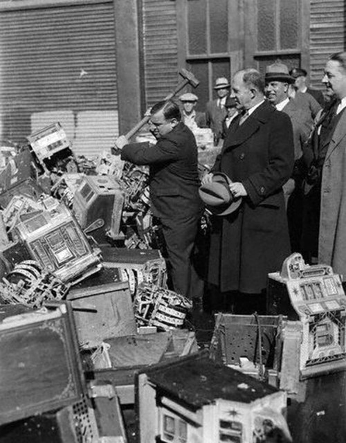 Mayor LaGuardia smashing confiscated pinball machines, 1934. He was on a crusade to put an end to ma