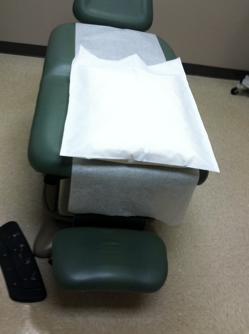 gynie-ville:  At the proctologist, she leans over the tilt-table for a thorough rectal