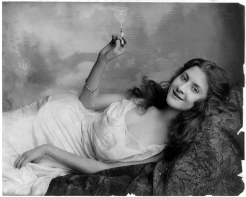 A young lady enjoying what we assume to be tobacco. Although her facial expression suggests otherwis