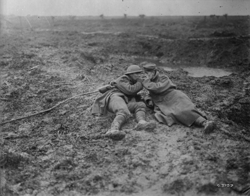 scrapironflotilla: Wounded Canadian and wounded German lighting a cigarette on Passchendale battlefi