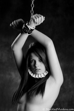 shackledmaidens-com:  Small Sample Image from todays Update  Nicola - Leather CuffsCute little Nicola, slowly cuffs and collars her self before securing her hands above her head, she sits there just waiting to find out what i plan to do with her next.Join