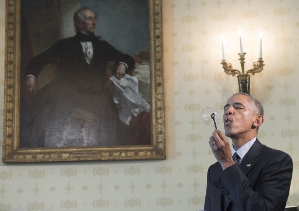 US President Barack Obama blows a bubble using a bubble wand created with a 3D printer