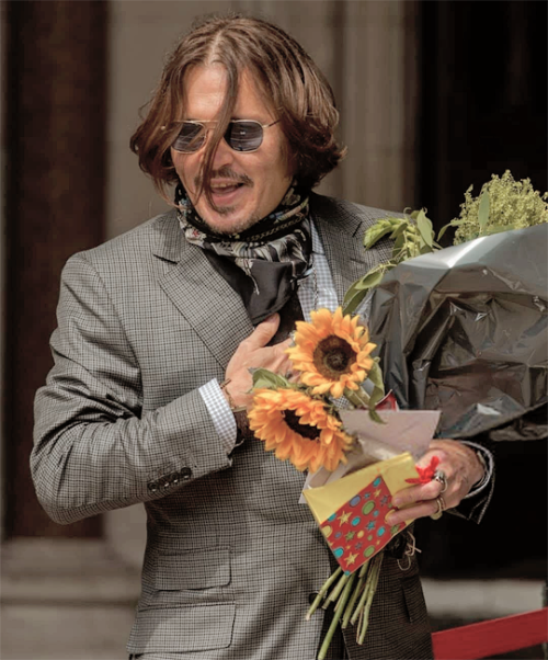 dailyjdepp:Johnny Depp receiving flowers and cards from his fans outside the court in London.