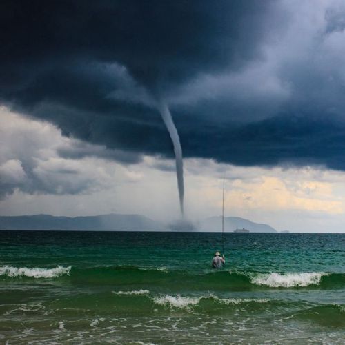 natgeoyourshot:Top Shot: The Storm and The Fisherman Top Shot features the photo with the most votes