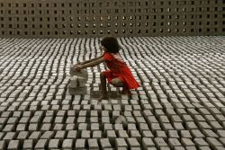 letswakeupworld:  A young girl stacks bricks