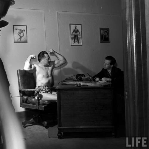 A day at the office with Charles Atlas*(Nina Leen. 1942?)* It looks like Charles Atlas