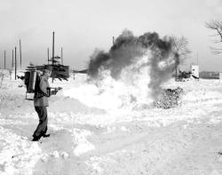 weirdvintage:  Tired of shoveling snow, Sargent Robert. G. Evraets uses a flame thrower to clear a path through the frozen Governors Island, 1947 (via) 