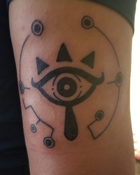 Breath of the wild shiekah eye done at rising dragon tattoos in new york. 
