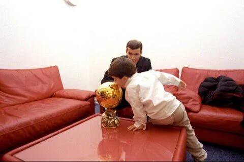 Enzo Zidane kisses his father’s Ballon d’Or in 1998.