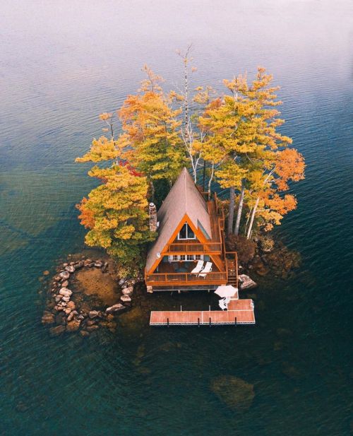 cabinporn:  This a-frame is on an island in Lake Winnipesaukee, New Hampshire. The island is about 20 feet from the shore of Oliver Lodge. There’s a floating dock used for sunbathing, canoes and small boats.The house faces due south and receives sun