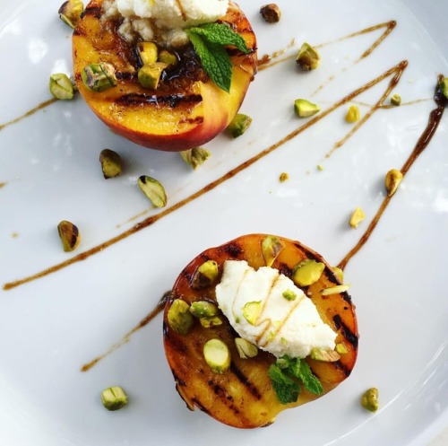 Grilled Peaches topped with Ricotta Cheese and Balsamic Glaze garnished with roasted pistachios and 