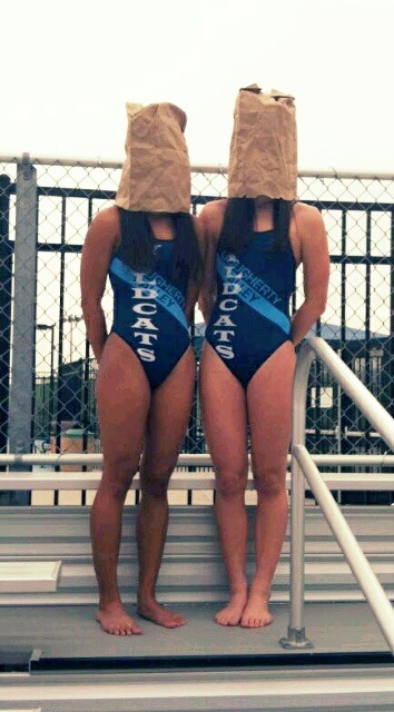 For skipping practice, these two were stood at attention for the entire swim meet with paper bags ov