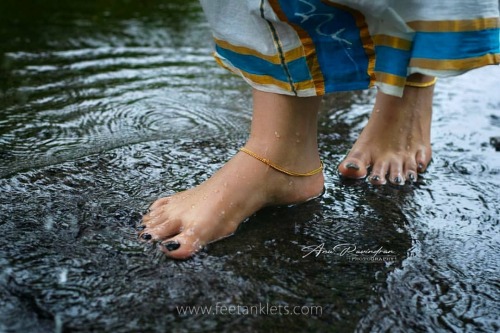 Her feets drenched in rain, And the water flowing besides her, Calms the mind from the pain, And jus