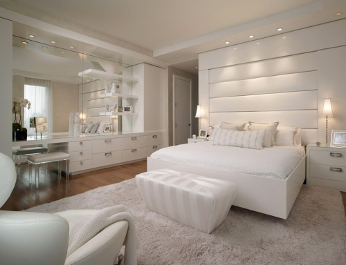 Bright and inviting white bedroom with Toshiyuki Kita&rsquo;s ever comfortable Dodo reclining chair.