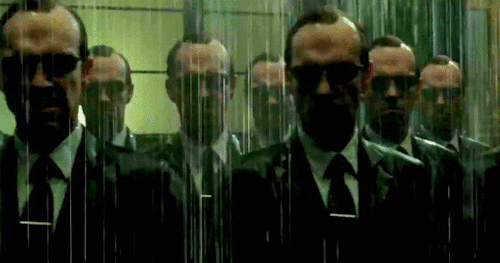 A panning shot of many Agent Smiths from The Matrix: Revolutions