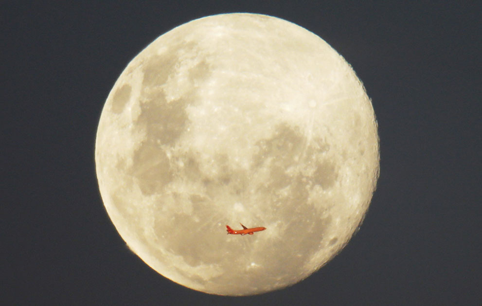 ruckawriter:  A Virgin Airlines aircraft, illuminated by the setting sun in front