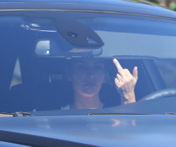 kimkanyekimye:   Kim Kardashian West seen out in Calabasas earlier today giving the paparazzi the finger 8/26/14  