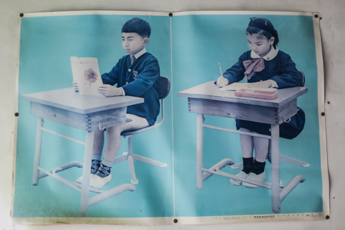 Sit up straight!  A poster showing correct posture at a long forgotten wooden school house hidden aw