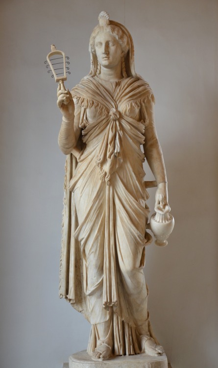 A marble statue of the goddess Isis, holding her characteristic instrument, the sistrum (rattle). &n