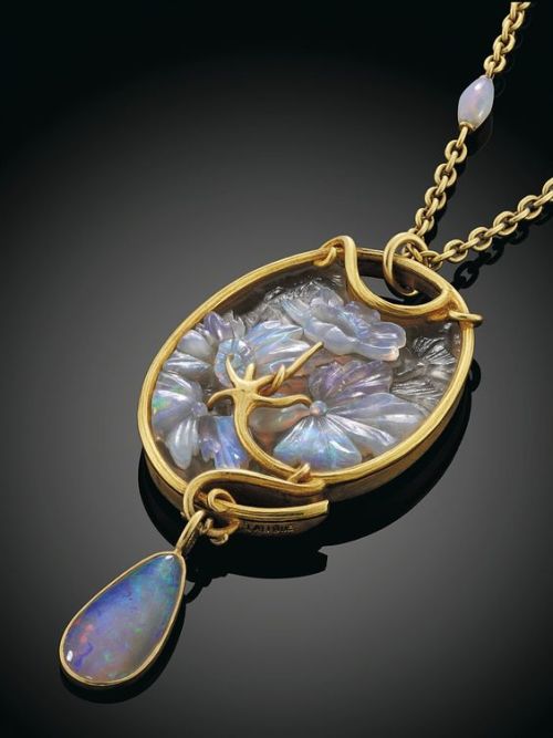 AN ART NOUVEAU OPAL AND GLASS GOLD MOUNTED PENDANT, BY LALIQUE The carved opal flowers and foliage a