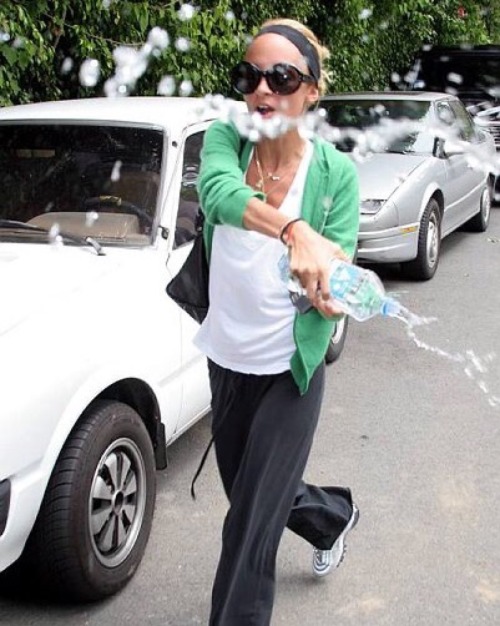 popculturediedin2009:Nicole Richie throws water at paparazzi, June 2006