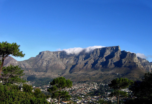 Table Mountain is a flat-topped mountain forming a prominent landmark overlooking the city of Cape T