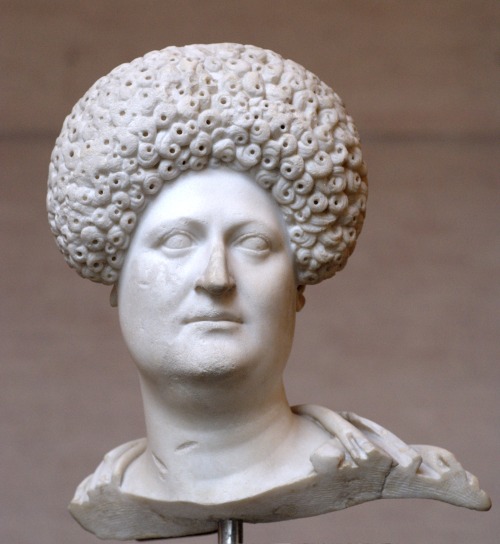 Bust of a Roman woman, sporting the raised hairstyle popular during the Flavian dynasty (69-96 CE). 