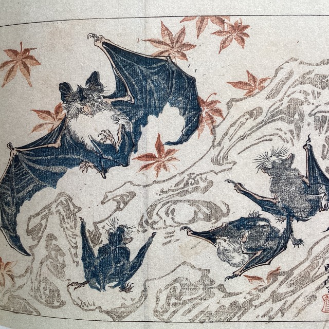 Colored woodblock prints depicting four bats. One bat has its wings opened and the mouth wide open. Three bats appear to be hanging onto a tree that’s printed in light greyish brown contour lines.