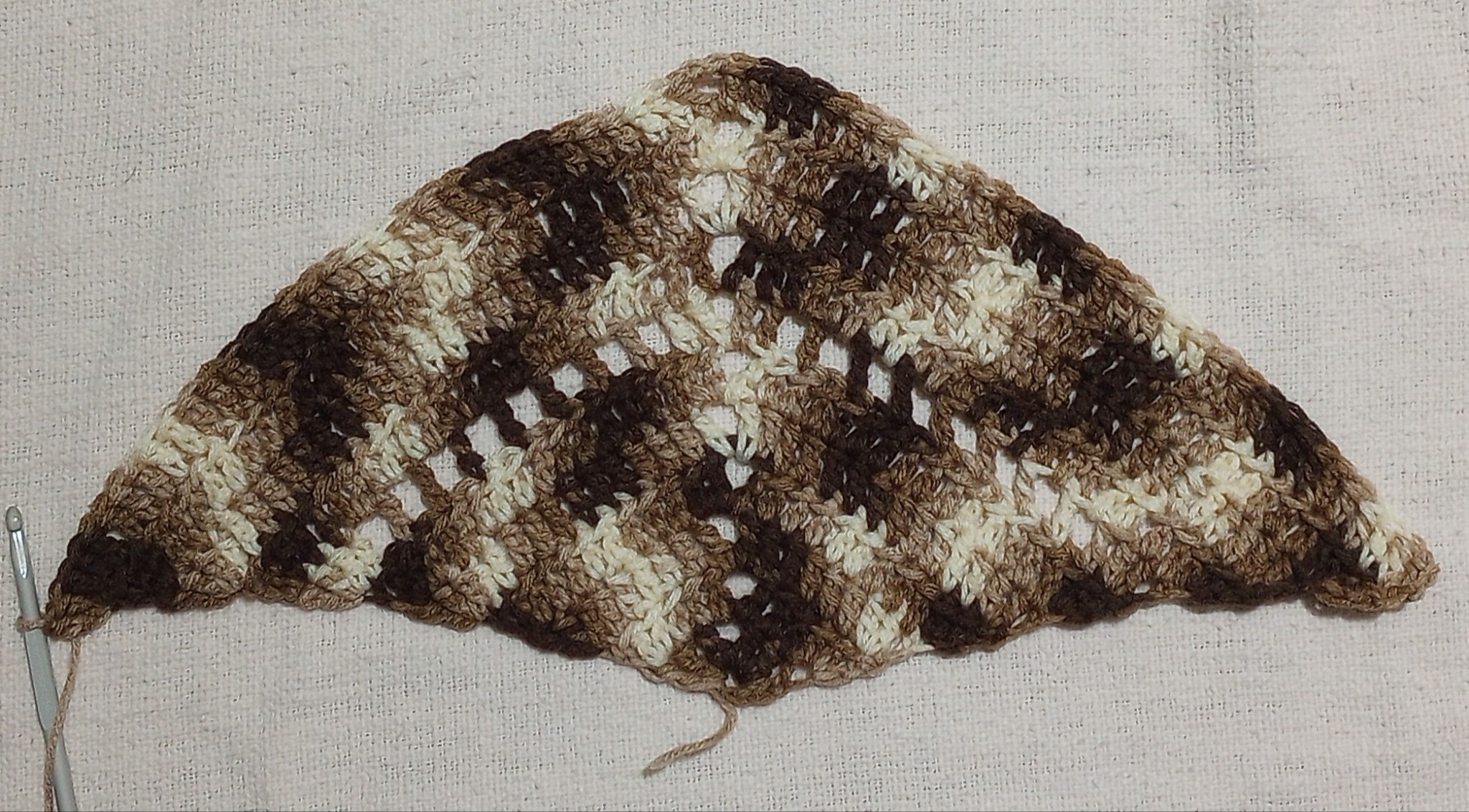 early stages of a brown crochet shawl