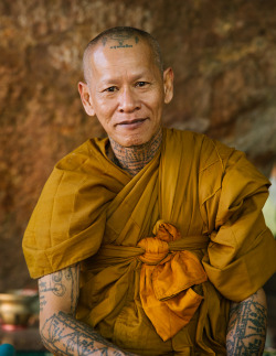 jessicasample:  A tattooed monk at Phnom Kulen, the site of the largest reclining buddha in Cambodia dating back to the 16th century.  Buddhist monks there believe that yantra tattooing has magical powers that ward off evil and hardship.