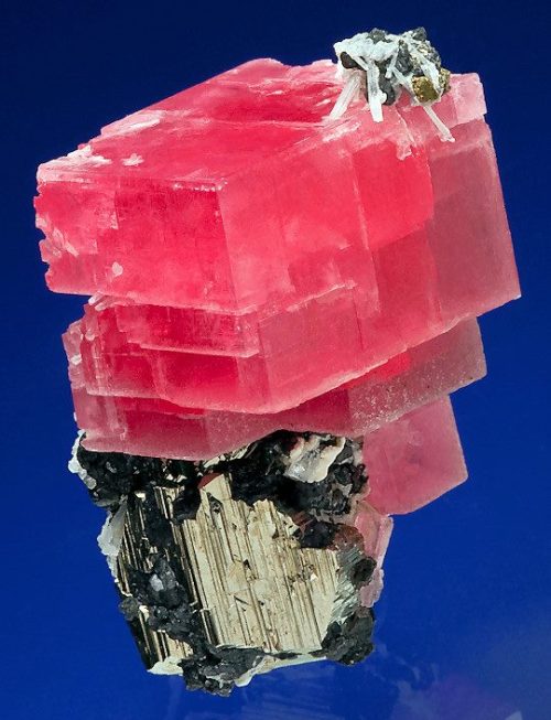 Rhodochrosite on pyrite. This beautiful specimen of manganese carbonate displays the rich pink of lo