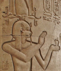 amntenofre:  King Ptolemy VIII Euergetes II offering a bowl with incense;the King wears the Nemes topped by ram’s horns with four uraei and a composite White Crown flanked by the two feathers.  Double Temple of Haroer (Ḥr-wr, Horus the Ancient) and