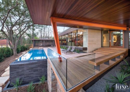 luxe-interiors-and-design:  A Modern Dallas Home With Wood And Stone Exterior Wood and stone allow a modern Dallas home to embrace its forested hilltop setting and create a warm backdrop for an impressive art collection. Read about this home. / Tour this