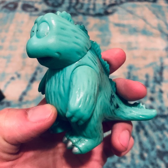 monsterislandbuddies:Godzilland (?) Squeaky Toy (1984)This little guy has seen better days! He’s lost the white in his eyes and he’s very scuffed up. His squeak is still loud as hell. His foot marks him at 1984, which matches the year of the “Godzilland”