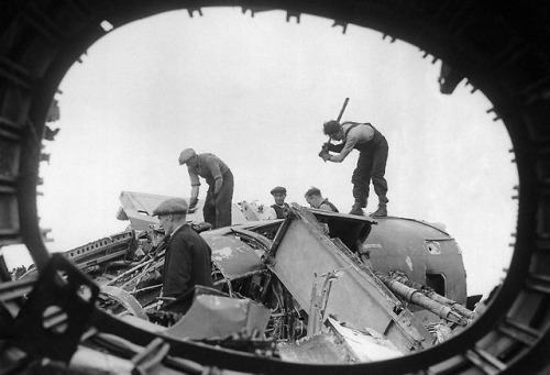 Workers in a salvage yard breaking up the remains of German planes shot down over England (August 26