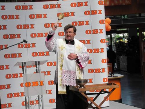 Polish priest blessing a newly-opened hardware store. Ostrołęka, 2014.