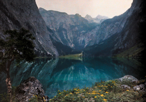 This glacial lake sits between mountains and a wild crag in Bavaria, Germany, December 1928.Photogra