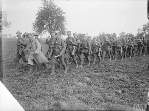 Men of the 1st Battalion, Wiltshire Regiment, returning with German caps, helmets and other trophies