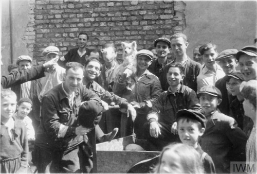 A group of Jewish men and children pose for a photograph in thestreets of the Warsaw Ghetto (Poland,