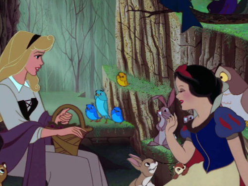 A digitally composited image of Aurora and Snow White, created using Disney screencaps. Aurora and Snow White are sitting in a forest together, smiling at one another, with forest animals all around them.